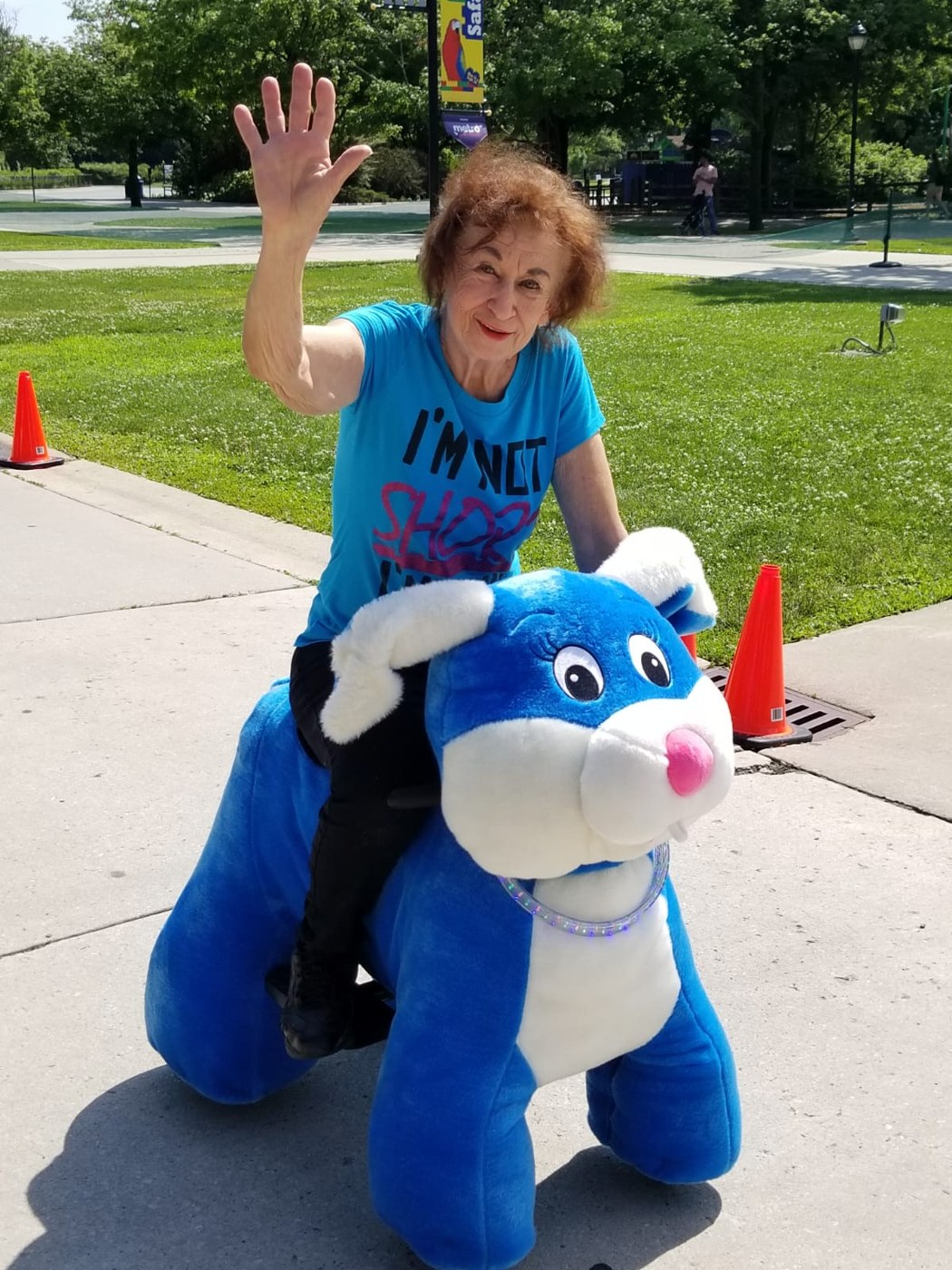 Guest smiling on a blue animal ride